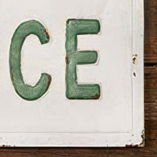 Close-up detail of embossed metal letter craftsmanship on Fresh Produce farmhouse sign