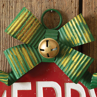  Close-up of green and gold striped ribbon bow with jingle bell detail on Christmas ornament sign