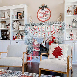 Peace on Earth ornament sign above fireplace mantel with Merry Christmas banner and holiday home decor