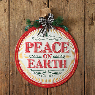 Peace on Earth round ornament sign flat lay showing buffalo check bow burlap hanger and pine sprigs