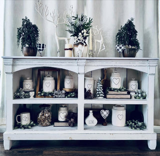 white reindeer on white console table with rae dunn and christmas decor