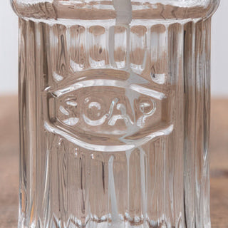 Embossed glass soap dispenser detail close-up