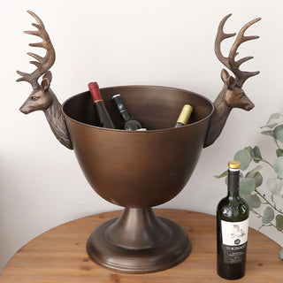 Woman posing beside bronze stag pedestal bowl showing close-up detail of sculpted deer head handle