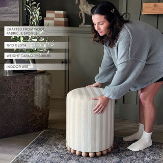 Woman moving striped fabric ottoman indoor seating