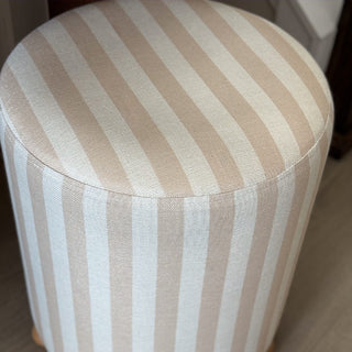 Beige striped upholstered ottoman top fabric detail