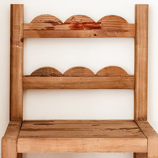 Closeup scalloped back cutout detail natural wood grain reclaimed bar stool