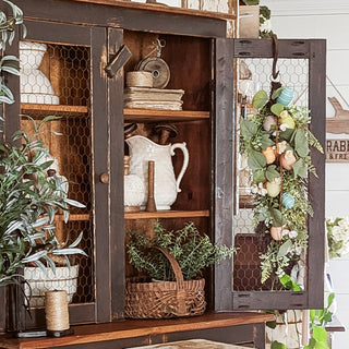 Rustic farmhouse cabinet styled with spring Easter decor