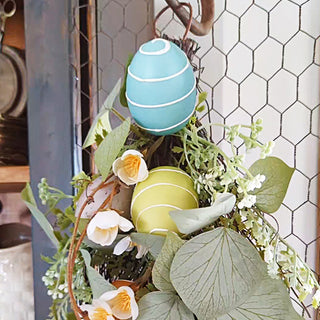 Pastel Easter eggs with faux greenery close-up