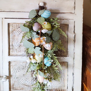 Spring Easter egg swag hanging on rustic door
