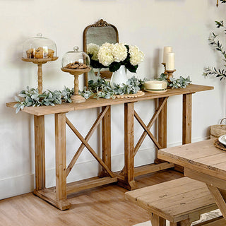 Wooden console table with decorative items in a room setting