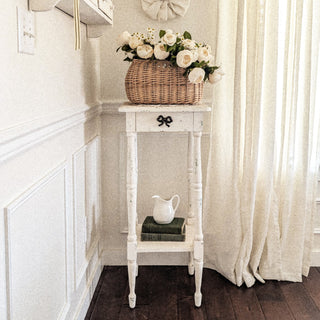 Distressed white farmhouse pedestal table with basket decor