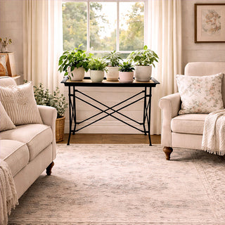 Black metal tray table with wood plank top styled with potted plants in bright living room