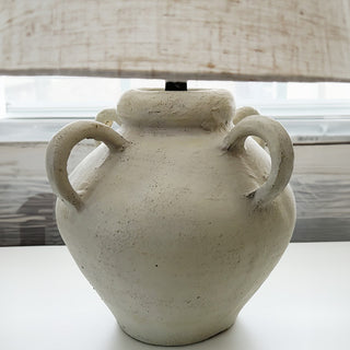 Distressed ceramic lamp base with double handles close-up