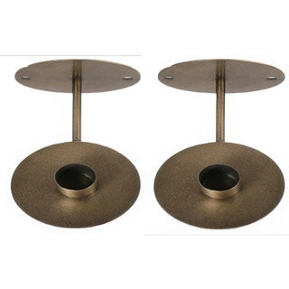 Two brass-colored wall-mounted candle holders on a white background