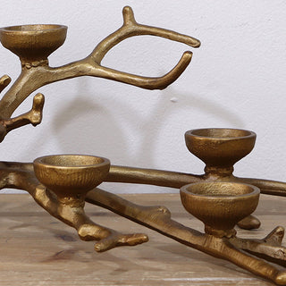  Close-up detail of cast iron branch tealight holder showing textured gold finish and candle cups