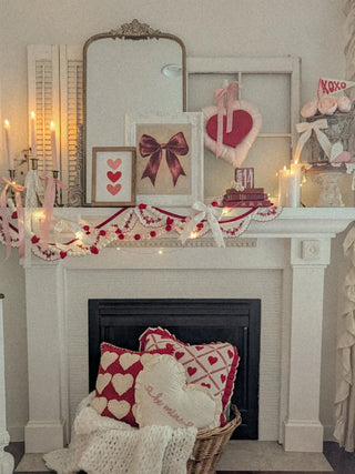 gold mirror on fireplace mantel with Valentine's Day decor