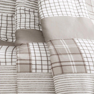 Gray plaid patchwork fabric throw blanket close up