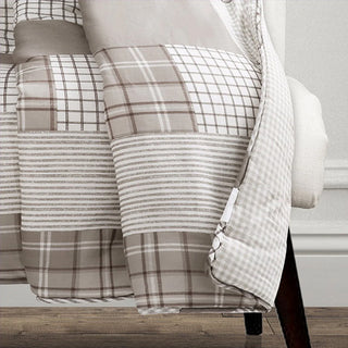 Soft neutral patchwork throw blanket draped detail