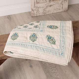 Folded block print cotton throw displaying botanical pattern and quality cotton craftsmanship
