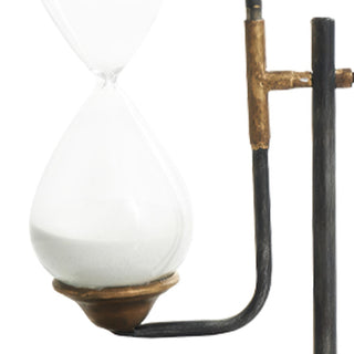 Close-up of vintage wind-up key detail and metal stand connection