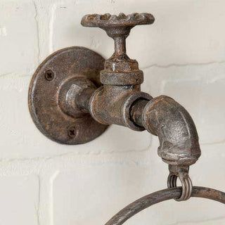 Close-up distressed metal faucet towel ring hardware