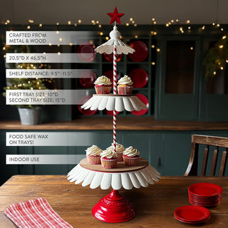 Three-tier metal and wood serving tray with red base and red star topper, holding cupcakes on a wooden table with festive kitchen decor