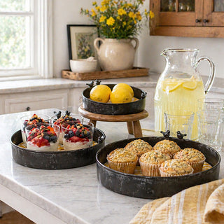 Graduated metal serving trays displaying breakfast treats and fresh lemons
