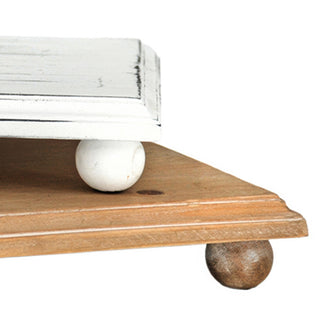 Close-up distressed wood riser ball feet detail