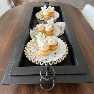 Medium and large nesting black metal trays with distressed finish on white background