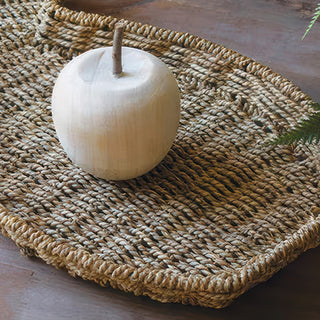 Natural seagrass woven bunny tray with decorative apple and fern spring styling