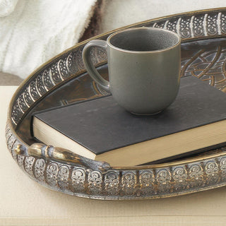 Nested oval metal trays with scroll handles and raised gallery edges in antique bronze finish