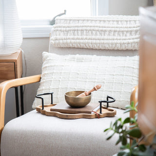 Farmhouse style bedroom chair featuring wood tray with bowl and home decor accessories