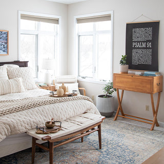 Modern bedroom interior showcasing wood and iron decorative tray on bed with neutral bedding