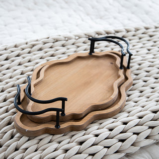 Detailed product shot of two nested scalloped edge wooden trays with black iron handles