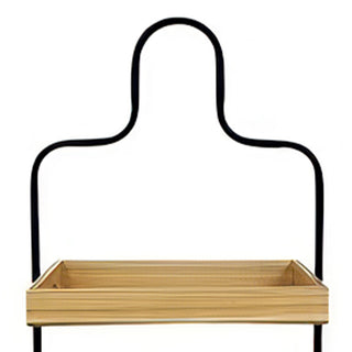 Close-up of sculptural curved black metal handle and top wood tray on 3-tier stand against white background