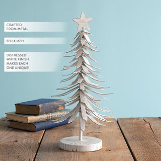  16 inch tall distressed white metal Christmas tree showing layered branch construction and wood grain base against light blue background