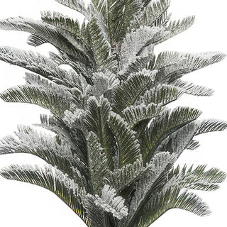 Close-up detail of heavy white flocking on realistic pine branches - winter wonderland snow-covered effect on artificial Christmas tree