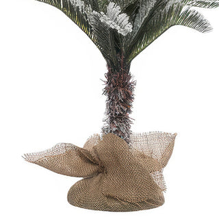 Burlap-wrapped weighted base with brown trunk detail on 4-foot flocked farmhouse Christmas tree - no tree skirt needed
