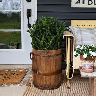 Brown wooden bucket planter front porch display