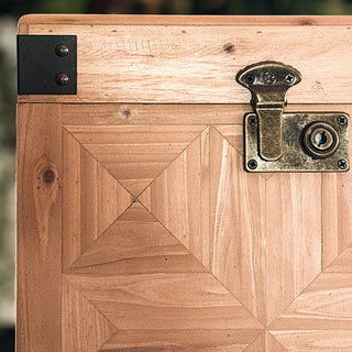 Stacked set of three carved wooden storage trunks with geometric panel detailing and metal hardware, styled in an elegant vintage living room for home décor and organization