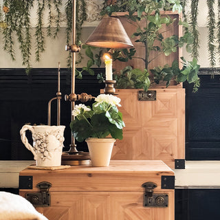 Stacked set of three carved wooden storage trunks with geometric panel detailing and metal hardware