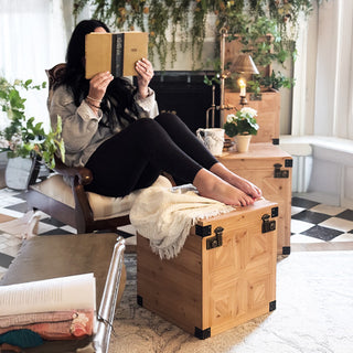 Stacked set of three carved wooden storage trunks with geometric panel detailing and metal hardware