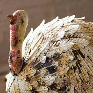 Close-up of handcrafted metal turkey showing distressed feather details