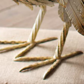 Detailed view of metal turkey sculpture feet with textured finish