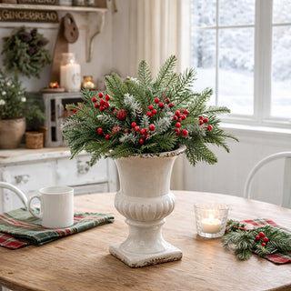 Rustic white ceramic urn with winter greenery centerpiece