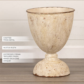 Distressed cream textured metal urn planter on pedestal base showing 14.5 inch by 19.5 inch dimensions crafted from metal with unique finish