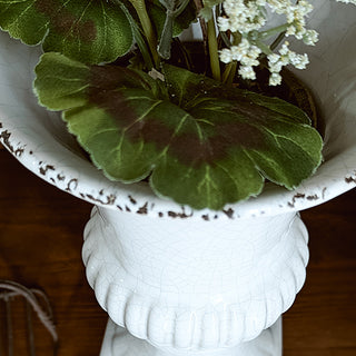 Farmhouse cabinet styled with white ceramic urn vase
