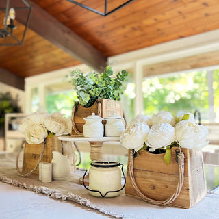 Farmhouse table centerpiece with three rustic recycled wood handbag planters, styled with white faux peonies and greenery