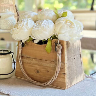 Rustic recycled wood handbag planter filled with white faux peonies, farmhouse-style floral table decor