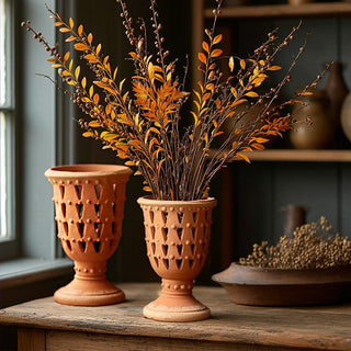 Set of terracotta perforated urns styled with orange fall branches, rustic farmhouse vase decor